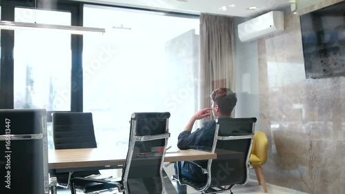 businessman relaxing in meeting room after compleated work photo