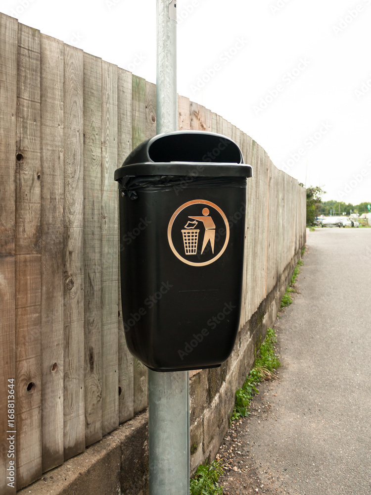 Obraz premium a public black bin on metal post isolated