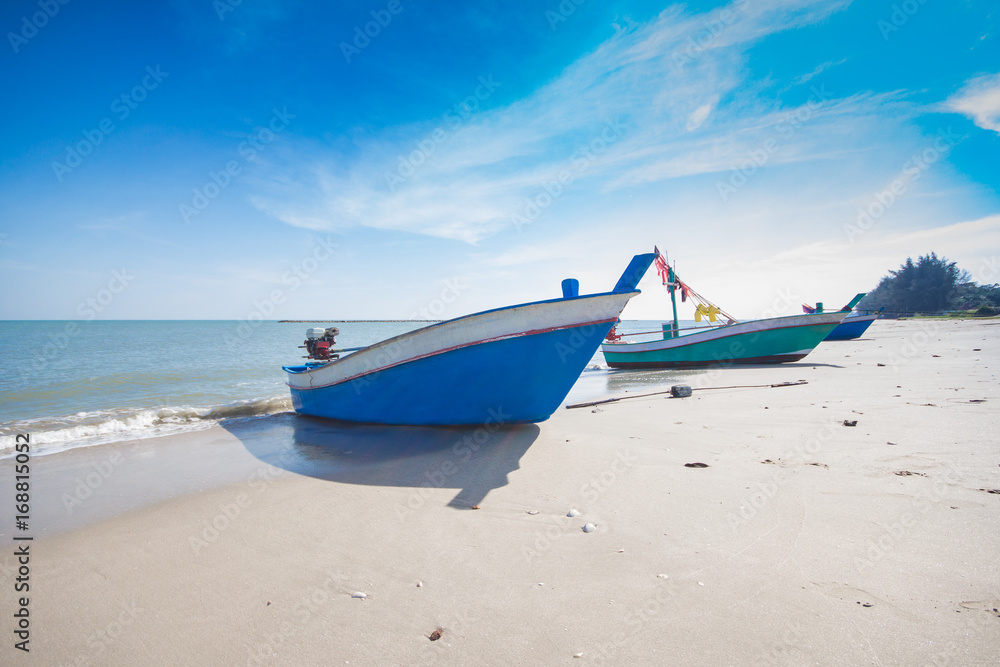 old wooden fishing boat Thailand beach with blue sky