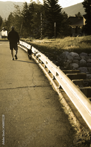 Man Walking Dog at Dawn