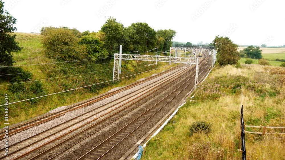 STAFFORDSHIRE, ENGLAND - 22ND AUGUST 2017: passenger train passing through countryside STAFFORDSHIRE, ENGLAND - 22ND AUGUST 2017: passenger train passing through countryside