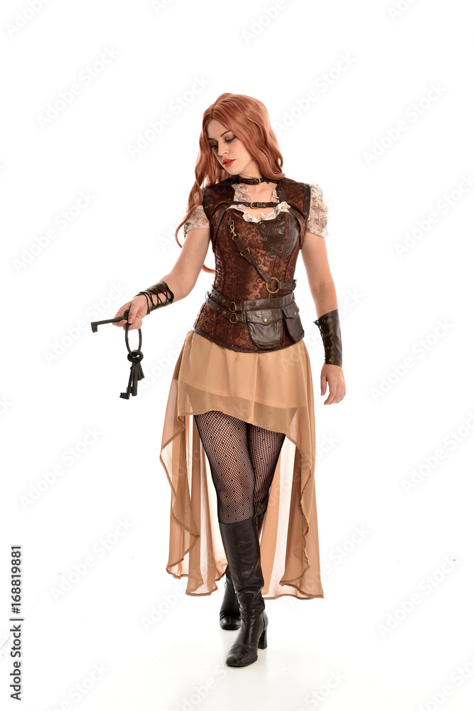 full length portrait of red haired lady wearing steampunk inspired outfit, standing pose against a white background. full length portrait of red haired lady wearing steampunk inspired outfit, standing pose against a white background.