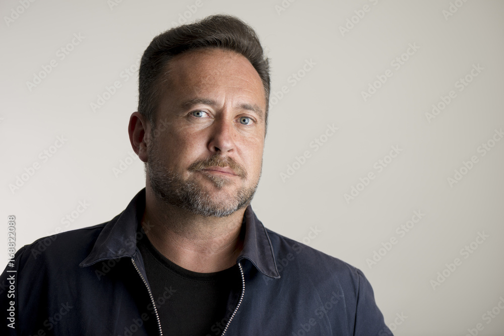 Adult Man in Jacket Over Gray Background with Copy Space Adult Man in Jacket Over Gray Background with Copy Space
