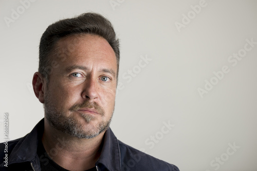 Portrait of an Adult Man Over Gray Background Copy Space