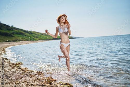 Fototapeta Naklejka Na Ścianę i Meble -  Young beautiful woman on vacation at sea, ocean, water, summer