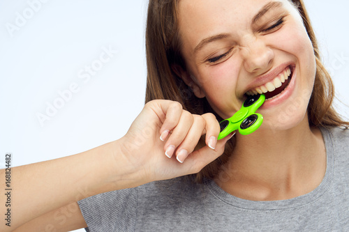 Young beautiful woman on white isolated background holds a spinner