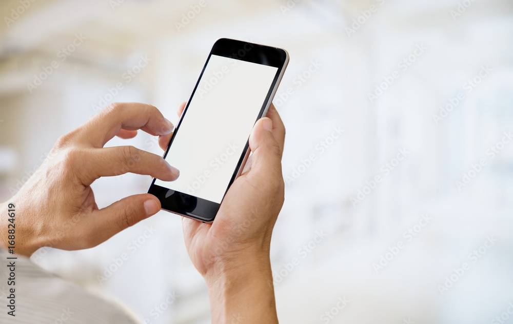 Man holding smart phone with blurred background. For Graphic display montage. Man holding smart phone with blurred background. For Graphic display montage.