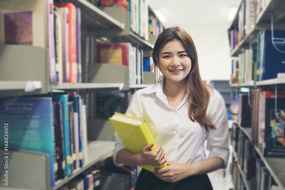 Young pretty Asian student smiling to camera. Education concept. Young pretty Asian student smiling to camera. Education concept.