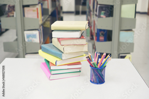 Image of Pile of books and stationery at library. Education concept.