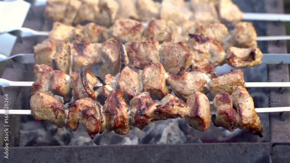 Grilling pork kebab on skewers at bbq, cooking process Grilling pork kebab on skewers at bbq, cooking process