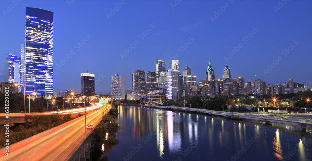 Philadelphia skyline illuminated and reflected into Schuylkill  River at dusk, USA 