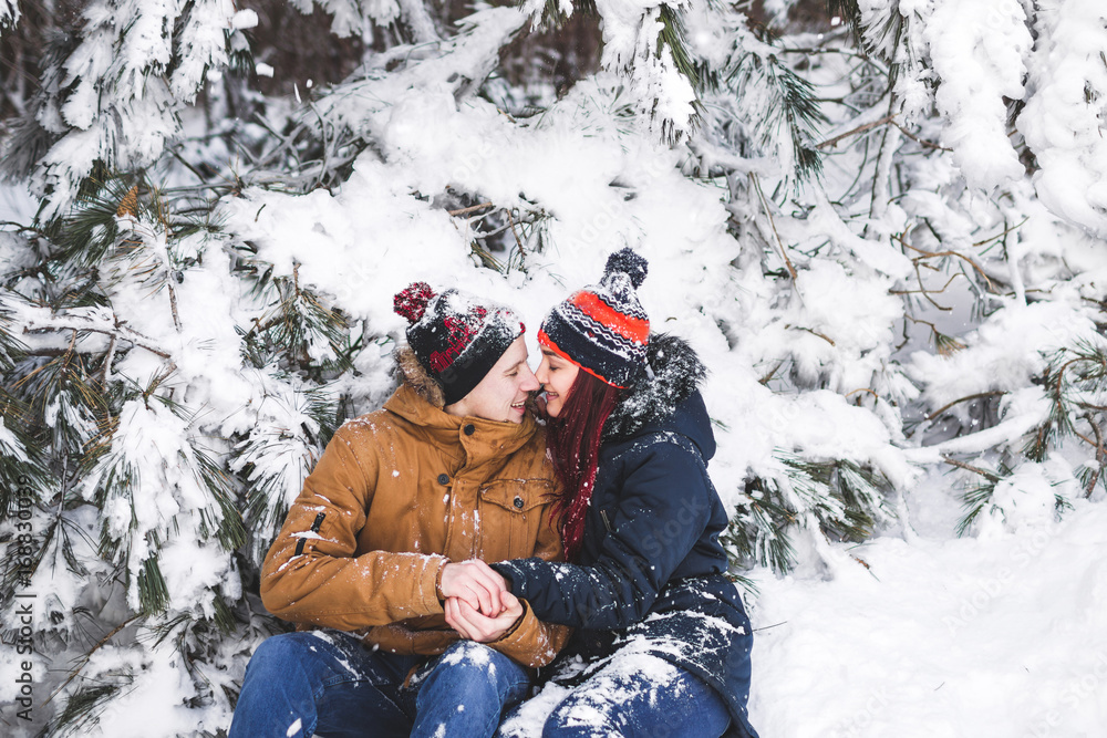 Сouple having fun and throwing snow in winter forest. A lot of snow around Сouple having fun and throwing snow in winter forest. A lot of snow around