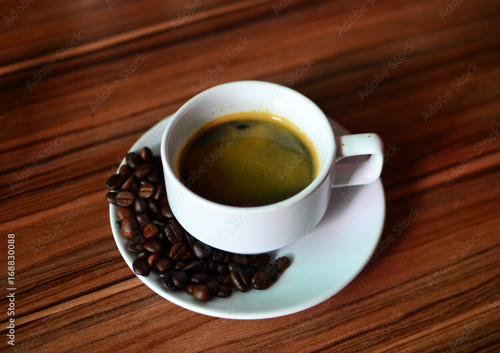 Fototapeta premium Hot American Coffee In a glass on a brown wood floor.