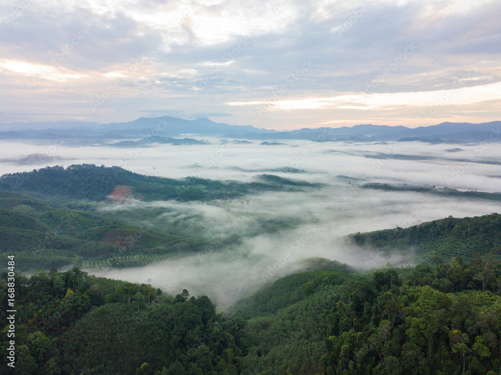 Obraz premium Landscape of misty mountain forest covered hills at khao khai nui