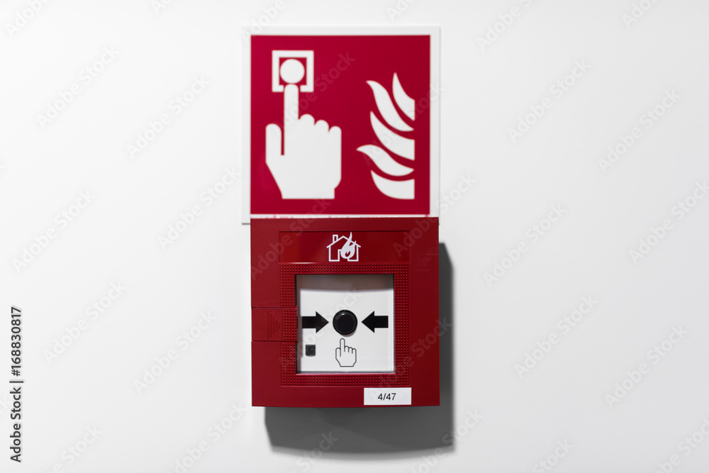 Red Fire alarm button on white wall Red Fire alarm button on white wall