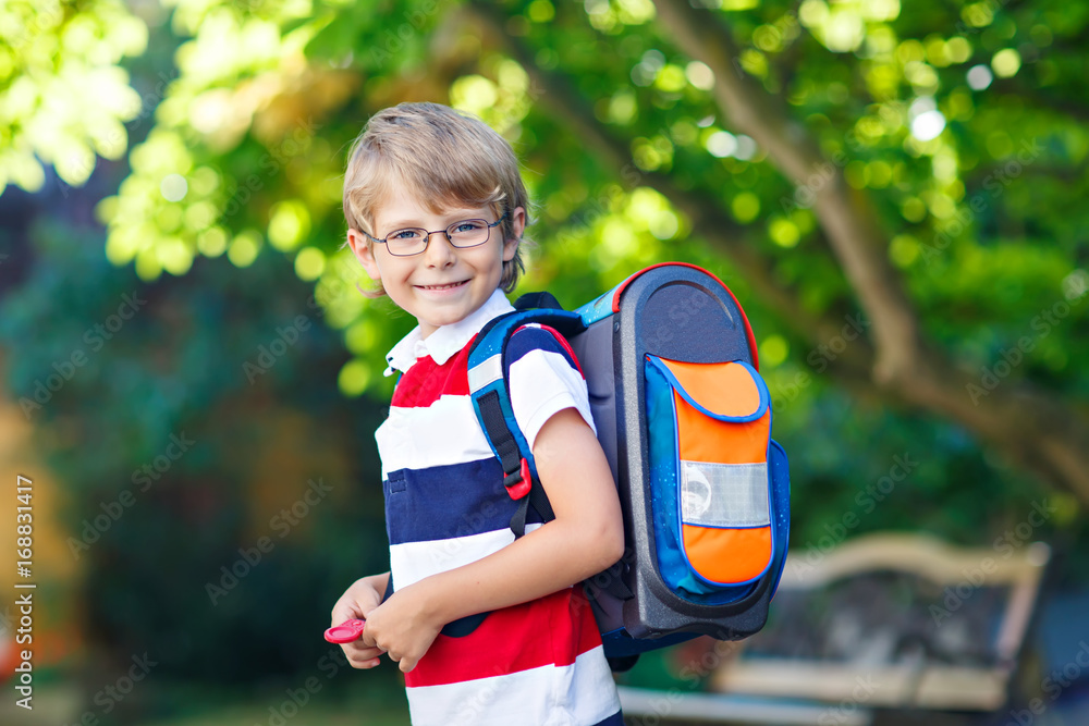 little kid boy with school satchel on first day to school little kid boy with school satchel on first day to school