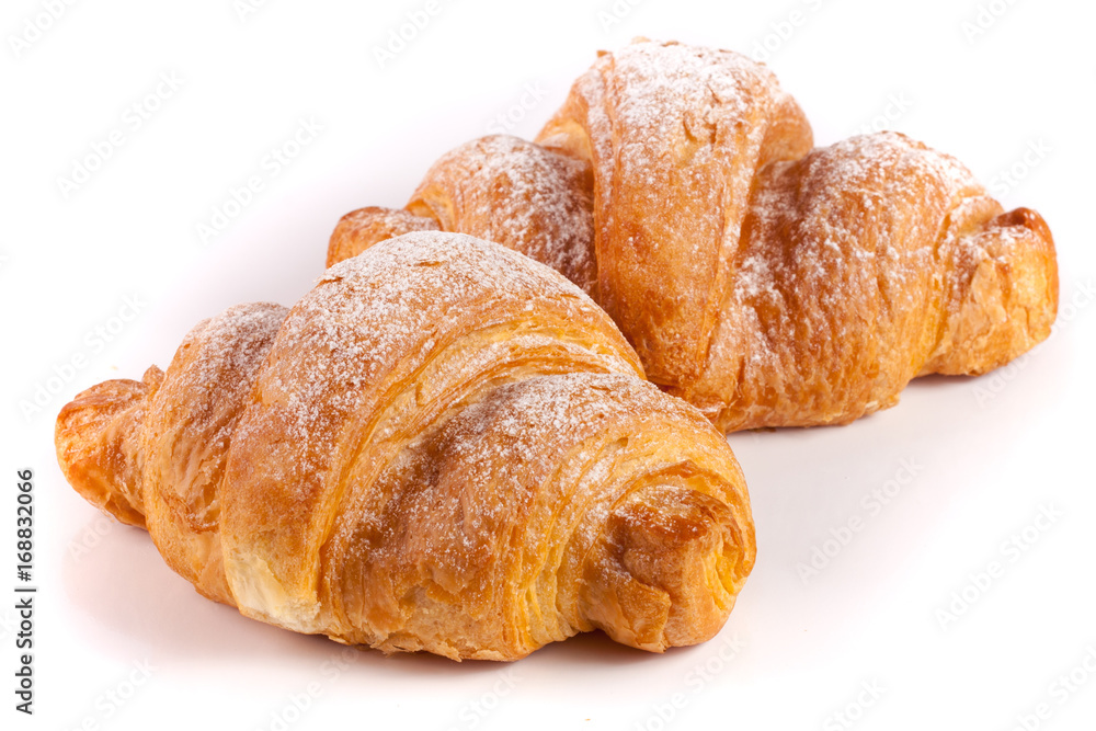 two croissant sprinkled with powdered sugar isolated on a white background closeup two croissant sprinkled with powdered sugar isolated on a white background closeup