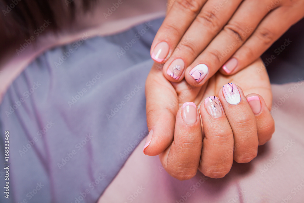 Beautiful female wrist with nail manicure closeup