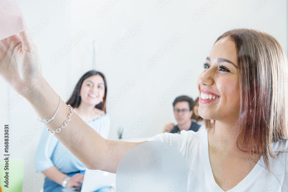 Cheerful girl with coworkers in office Cheerful girl with coworkers in office