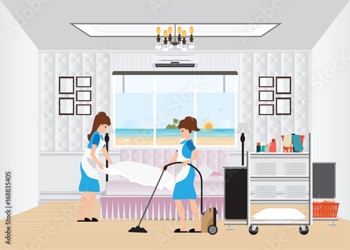 Maid cleaning hotel room with housekeeping trolley.