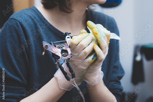 Tattoo machine on tattoo artist hand