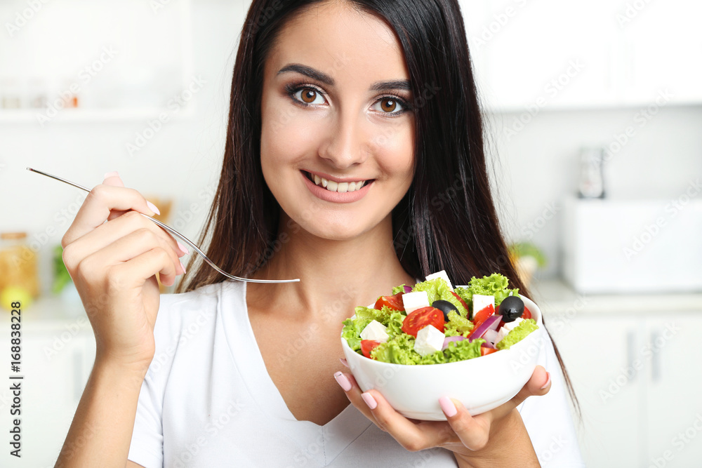 Beautiful young woman eating vegetable salad Beautiful young woman eating vegetable salad