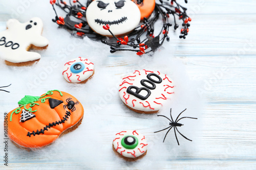 Fresh halloween gingerbread cookies on white wooden table © 5second