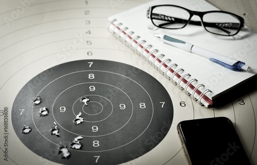 oal setting with target, objectives and planning concept, top view, You can make a great target of business like a bullet target photo