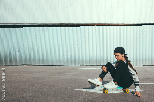 Pre teen skater on the city street