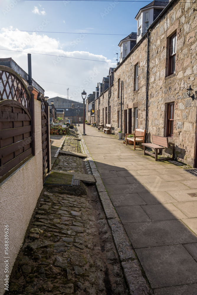 A quiet North Square walking street with two-storey granite houses next to the sea and beach in Aberdeen city