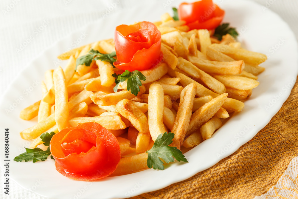 French fries potato on the plate with tomato French fries potato on the plate with tomato