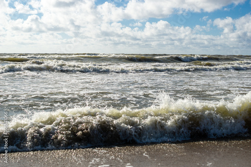 Beautiful beach landscape with sunset sky and soft waves over sand