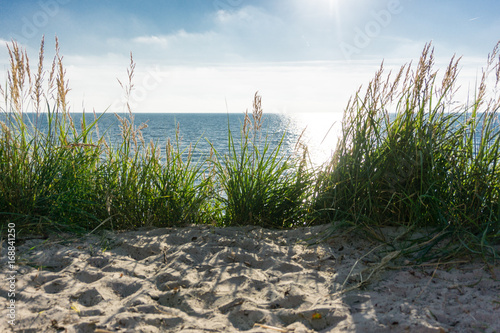 Beautiful beach landscape with sunset sky and soft waves over sand