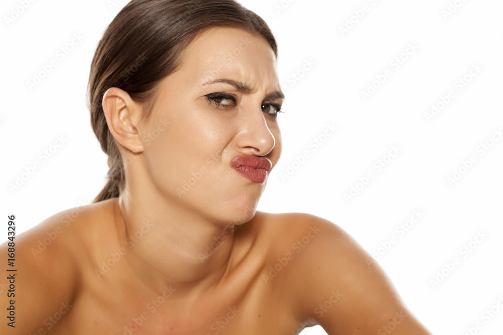 A young woman with negative expression pout her mouth A young woman with negative expression pout her mouth