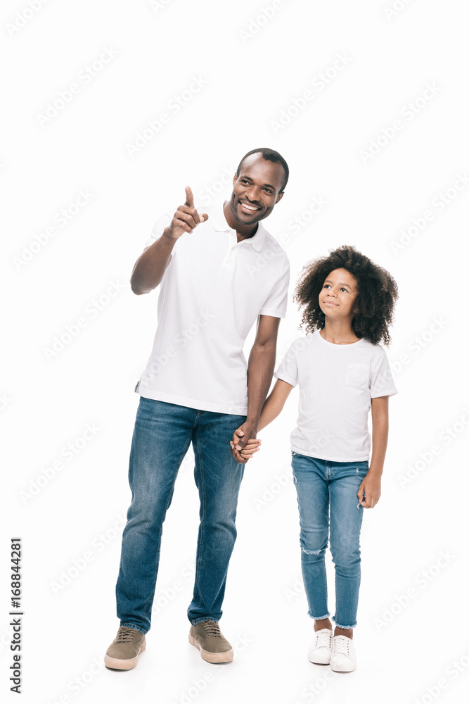 father with daughter pointing away father with daughter pointing away