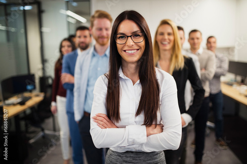 Business lady with positive look and cheerful smile posing for camera