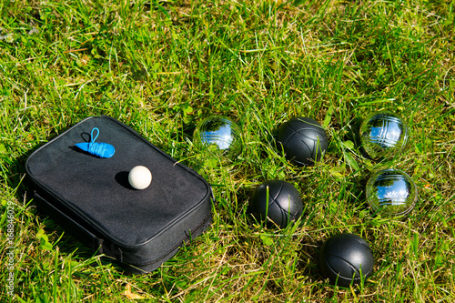 Set for playing bocce lies on a green lawn, photo