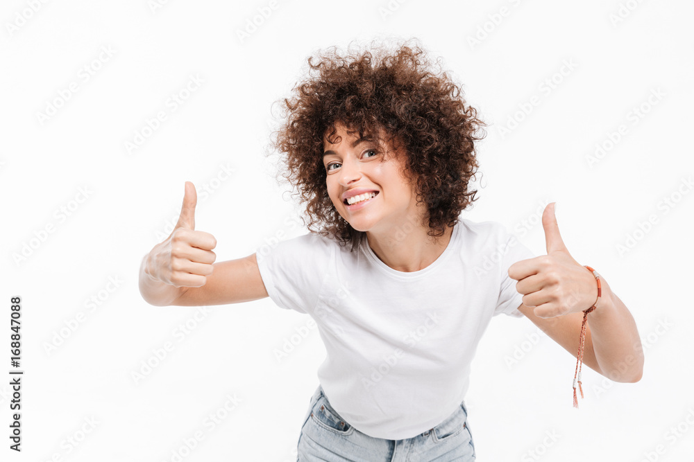 Happy smiling girl with curly hair showing two thumbs up Happy smiling girl with curly hair showing two thumbs up