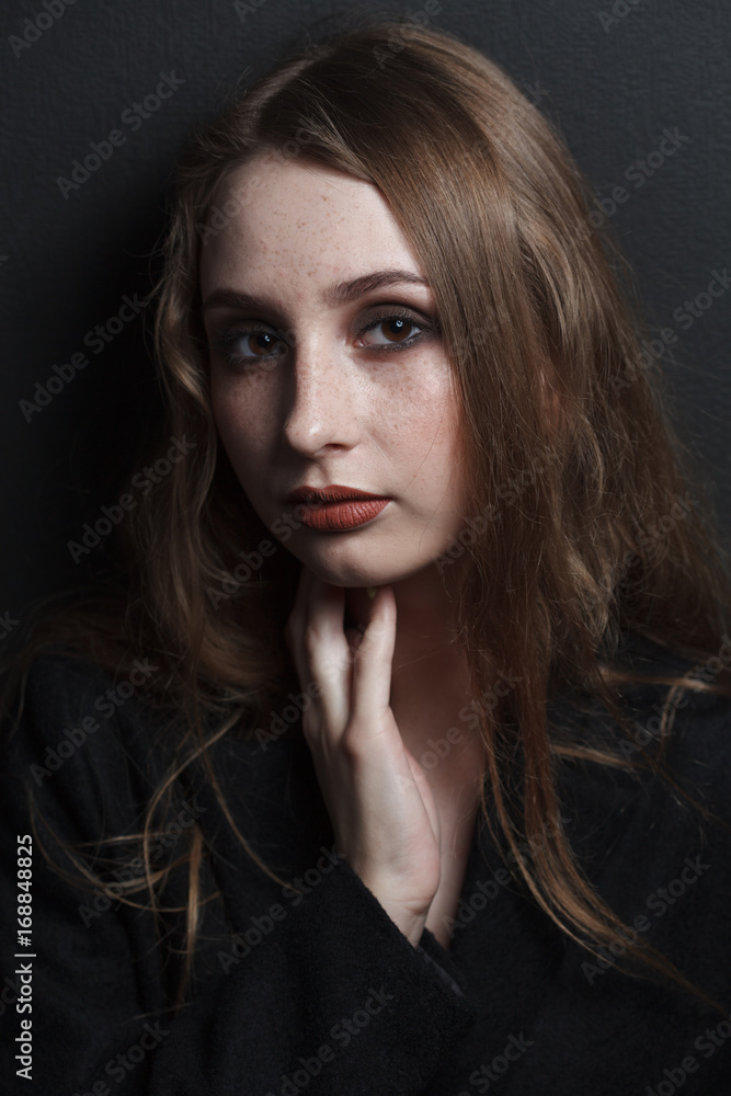 fashion studio portrait of beautiful young woman with long dark hair