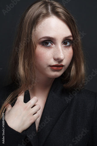 fashion studio portrait of beautiful young woman with long dark hair