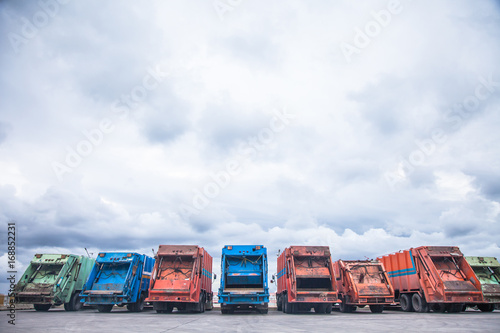 Several cars parked garbage truck for transport to garbage collection.