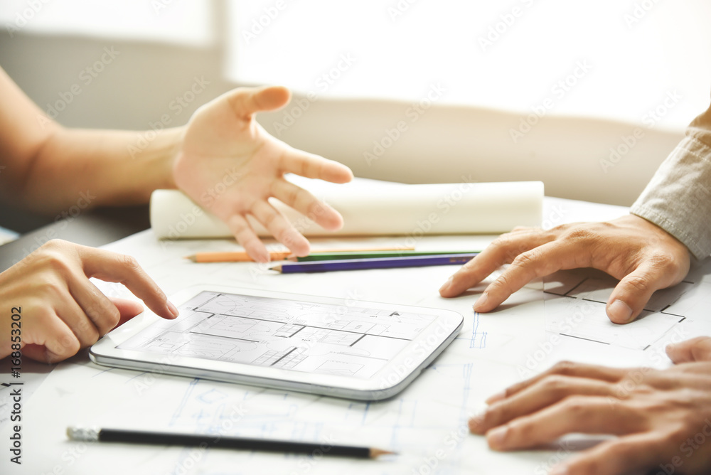 Designers discussing with tablet. Designers discussing with tablet.