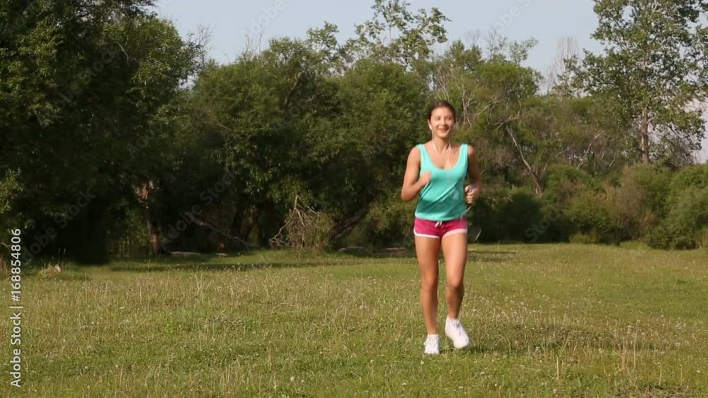 Young woman with a slender figure running outside the city. Young woman with a slender figure running outside the city.