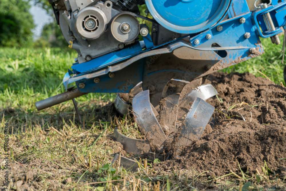 Dumping of land in the garden with a cultivator Dumping of land in the garden with a cultivator