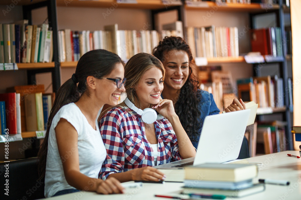 Group of female students study in the school library.Learning and preparing for university exam. Group of female students study in the school library.Learning and preparing for university exam.