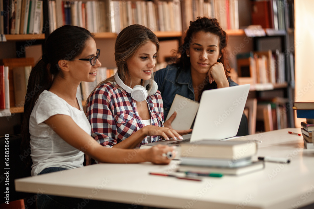 Group of female students study in the school library.Learning and preparing for university exam. Group of female students study in the school library.Learning and preparing for university exam.