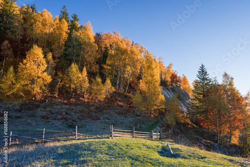 Autumn landscape with a wooden fence in a mountain village