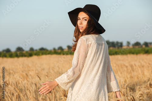 Beautiful young woman standing in the field
