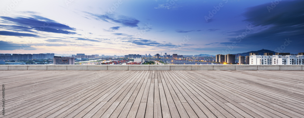 empty wooden floor and cityscape of modern city