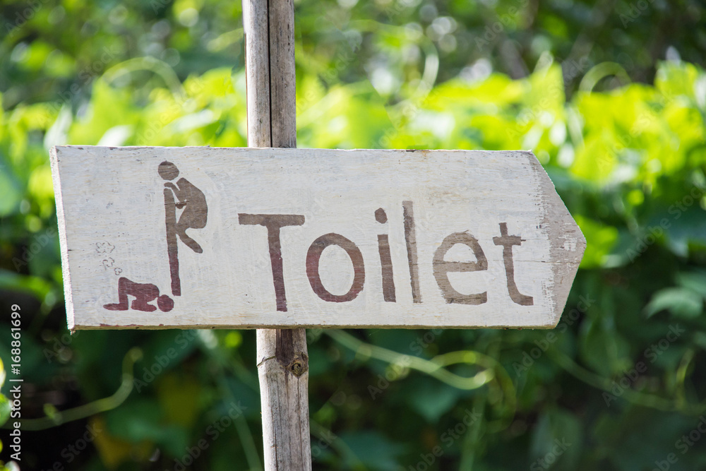 wooden sign Toilet with nature background.